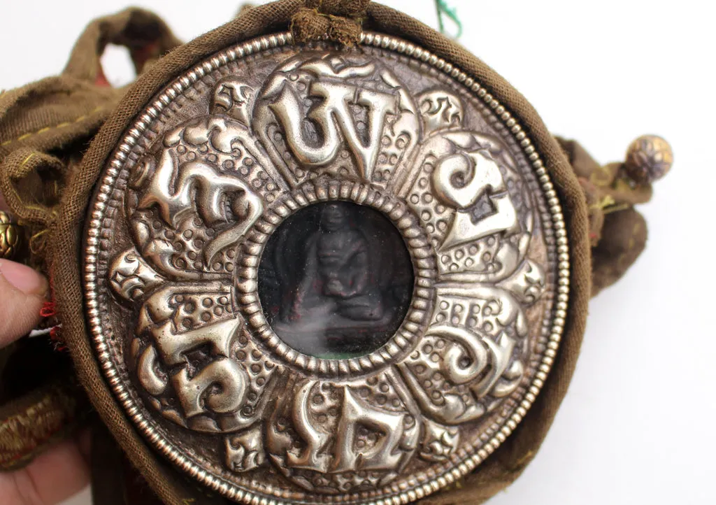 Om Mani Carved White Metal Shakyamuni Buddha Ghau Pendant in a Cotton Bag